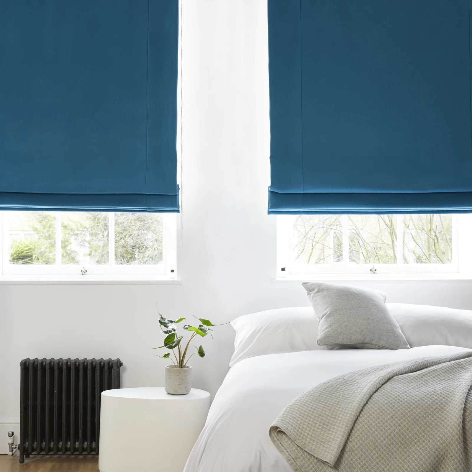 Aqua blue blackout roman blinds in white bedroom